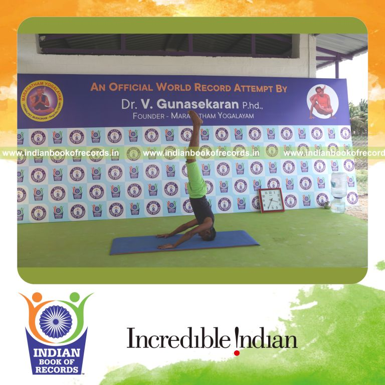 an individual holding mukta sirsasana yoga pose continuously for the longest duration with balance and control for a record in Indian Book of Records