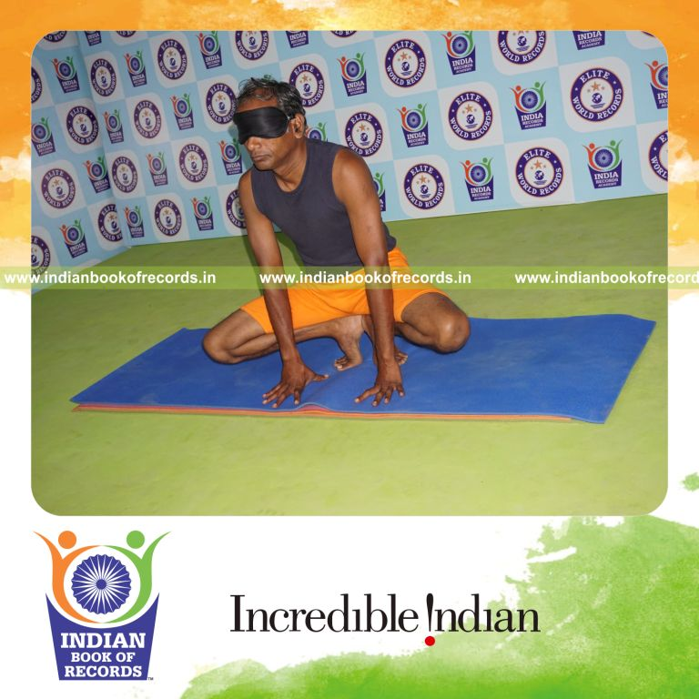 individual holding nagulasana yoga pose blindfolded for record in Indian Book of Records