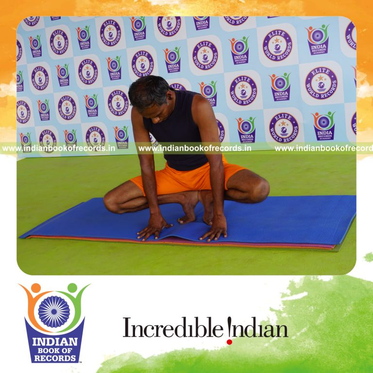 individual holding nagulasana yoga pose for record in Indian Book of Records