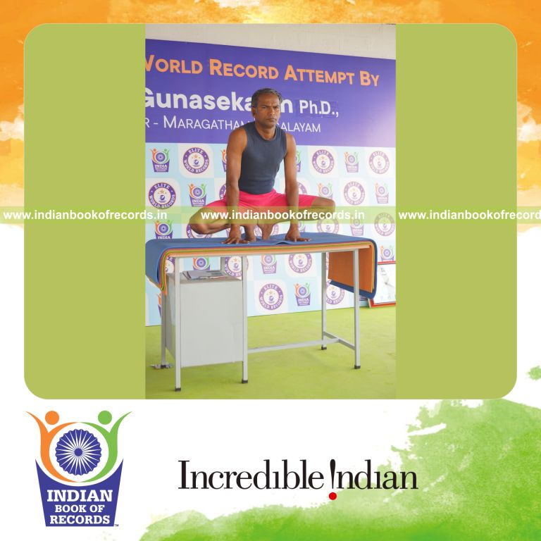 individual holding nagulasana yoga pose on a table for record in Indian Book of Records