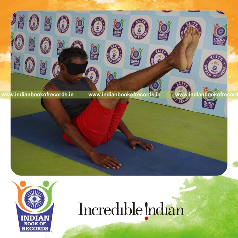 individual holding navasana yoga pose blindfolded for record in Indian Book of Records