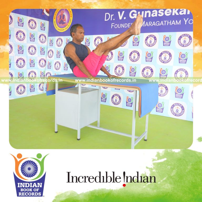 an individual holding navasana yoga pose on a table for the longest duration with balance and strength for a record in Indian Book of Records