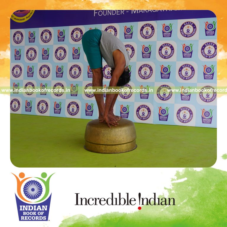 individual holding padahasthasana yoga pose blindfolded on a vessel for record in Indian Book of Records