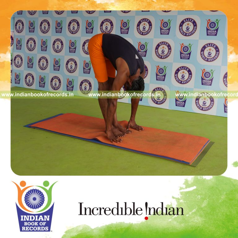 individual holding padahasthasana yoga pose for record in Indian Book of Records