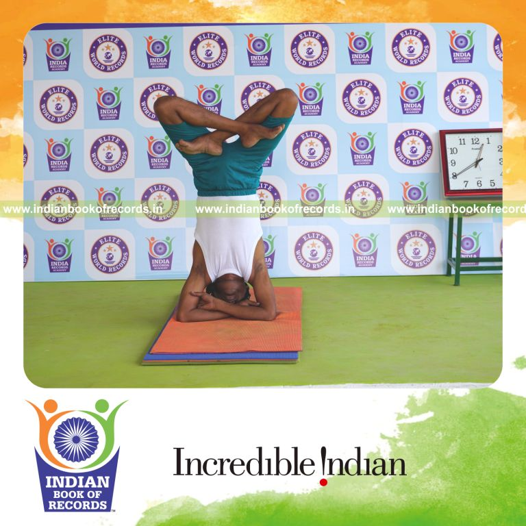 an individual holding padma baddha hastha sirsasana yoga pose blindfolded continuously for the longest duration with balance and control for a record in Indian Book of Records