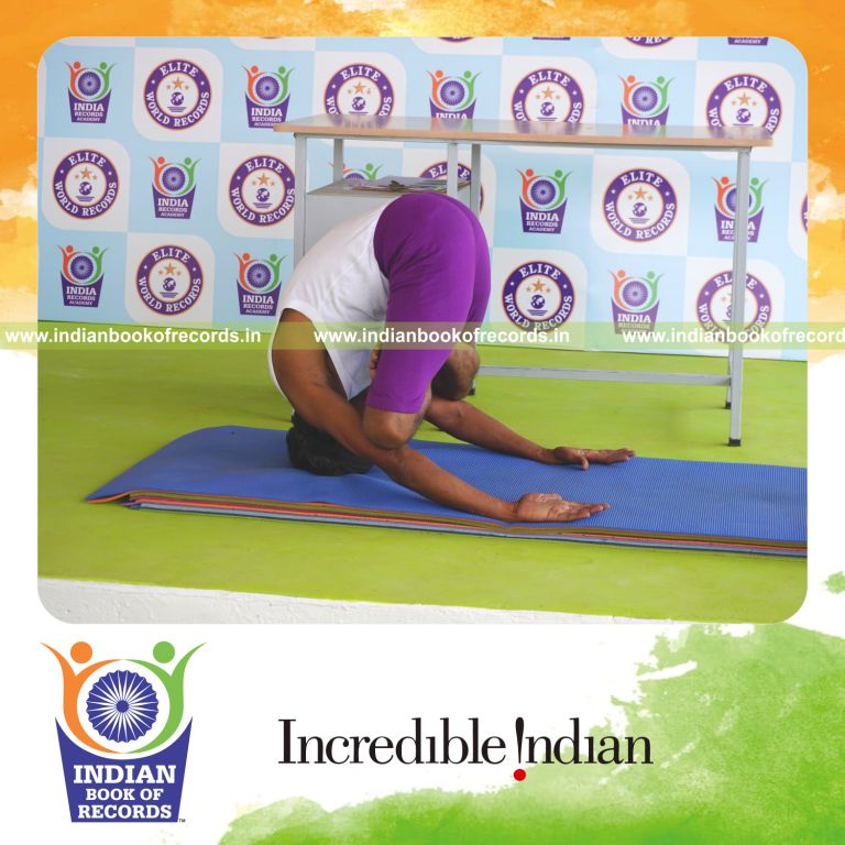 individual holding padma mukta sirsasana yoga pose blindfolded for record in Indian Book of Records