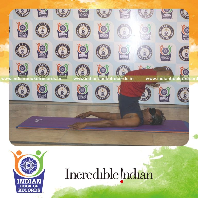 individual holding padma salamba sarvangasana yoga pose blindfolded for record in Indian Book of Records