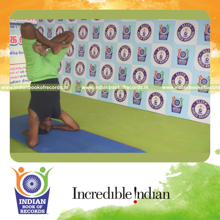 an individual holding padma salamba sirsasana yoga pose blindfolded for the longest duration with balance and stability for a record in Indian Book of Records