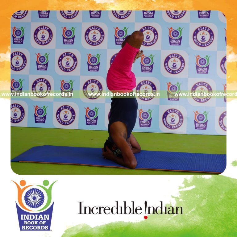 an individual holding padma sirsasana yoga pose blindfolded for the longest duration with strength and balance for a record in Indian Book of Records