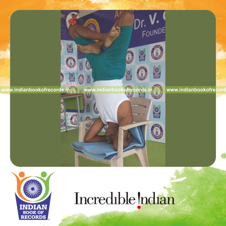 an individual holding padma sirsasana yoga pose on a chair continuously for the longest duration with balance and control for a record in Indian Book of Records