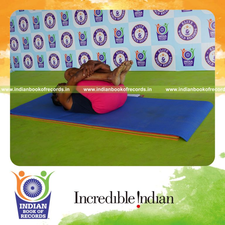 individual holding pavanamuktasana yoga pose blindfolded for record in Indian Book of Records