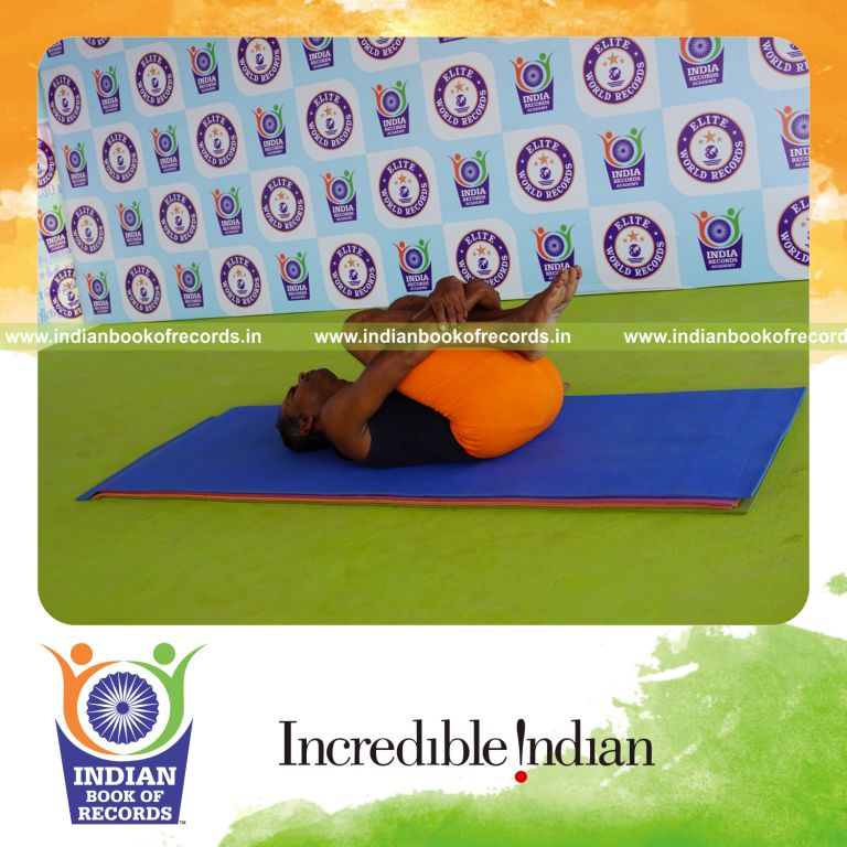 individual holding pavanamuktasana yoga pose for record in Indian Book of Records
