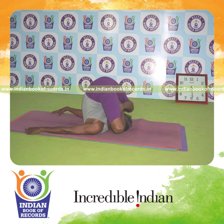 individual holding pindasana in salamba sarvangasana yoga pose blindfolded for record in Indian Book of Records