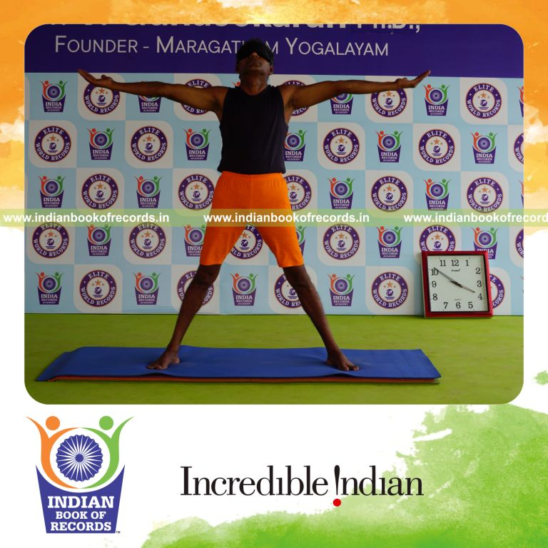 individual holding pirai chaturmukha trikonasana yoga pose blindfolded for record in Indian Book of Records
