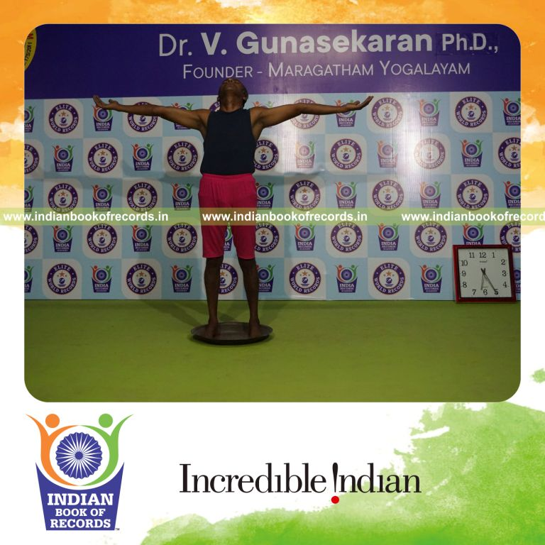 individual holding pirai chaturmukha trikonasana yoga pose on a brass plate for record in Indian Book of Records