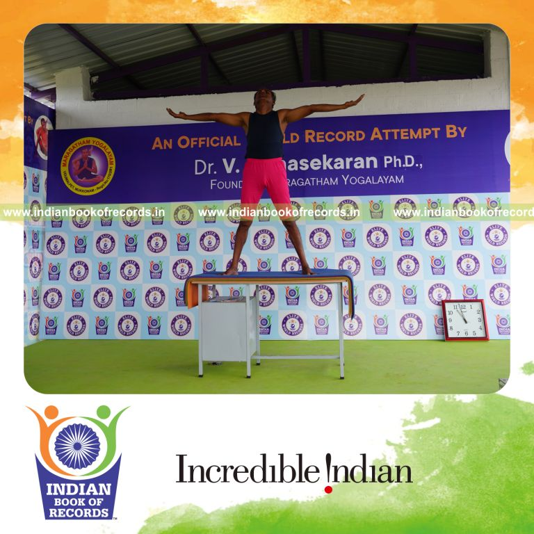 individual holding pirai chaturmukha trikonasana yoga pose on a table for record in Indian Book of Records