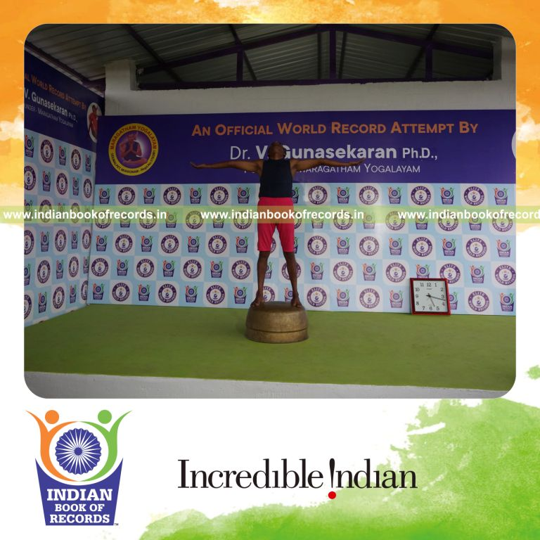individual holding pirai chaturmukha trikonasana yoga pose on a vessel for record in Indian Book of Records