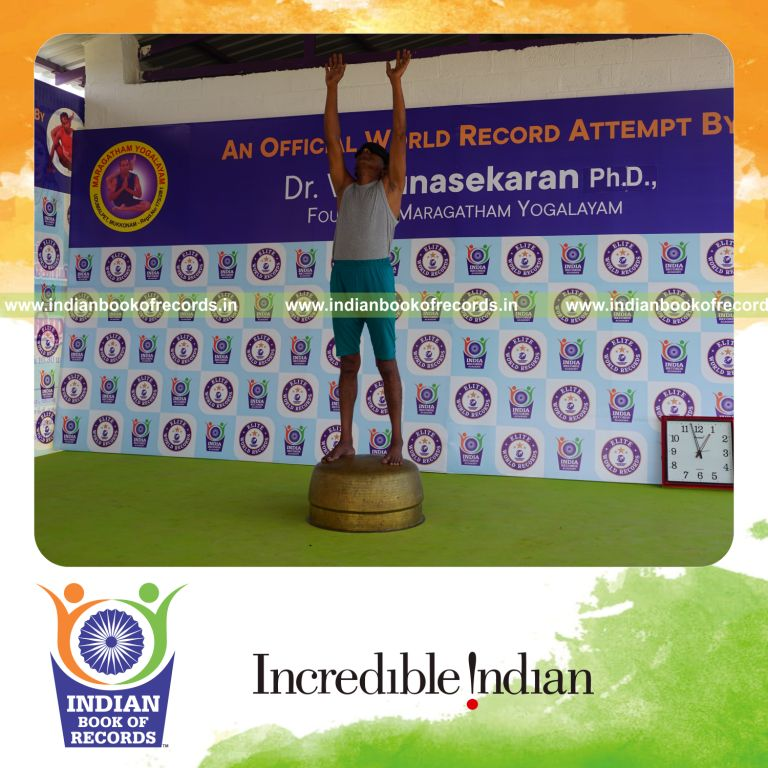 individual holding piraiasana yoga pose blindfolded on a vessel for record in Indian Book of Records