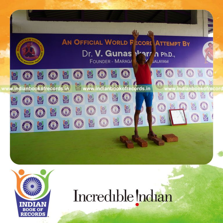 individual holding piraiasana yoga pose on bricks for record in Indian Book of Records