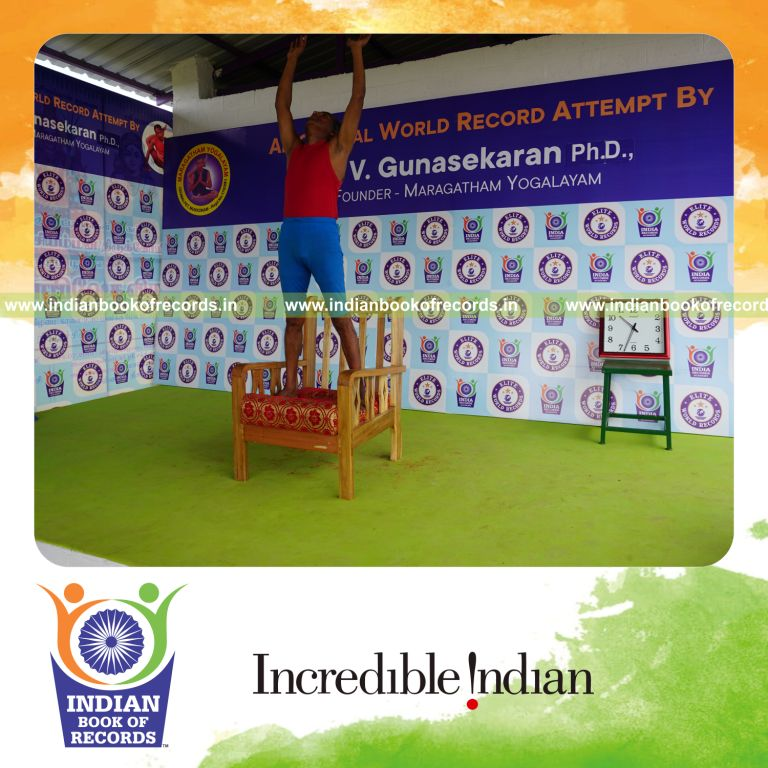 individual holding piraiasana yoga pose on a chair for record in Indian Book of Records