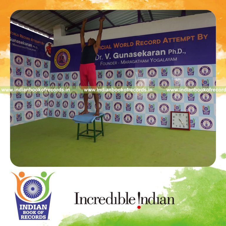 individual holding piraiasana yoga pose on a stool for record in Indian Book of Records