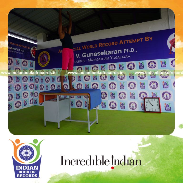 individual holding piraiasana yoga pose on a table for record in Indian Book of Records