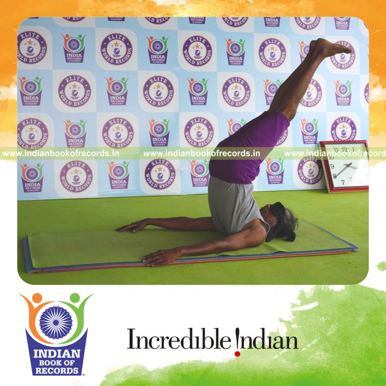 individual holding salamba sarvangasana yoga pose blindfolded for record in Indian Book of Records