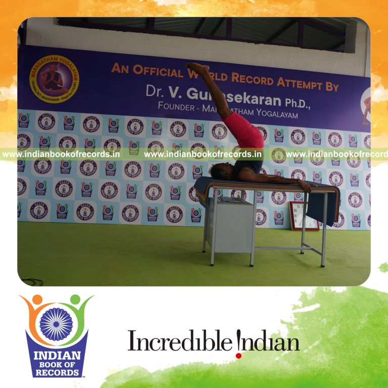 individual holding salamba sarvangasana yoga pose on a table for record in Indian Book of Records