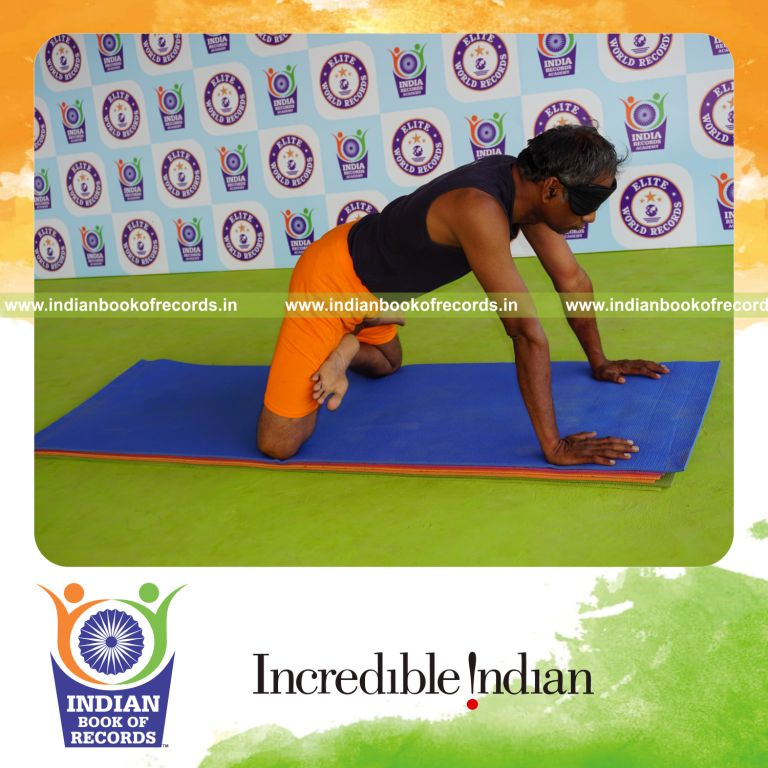 individual holding simhasana yoga pose blindfolded for record in Indian Book of Records