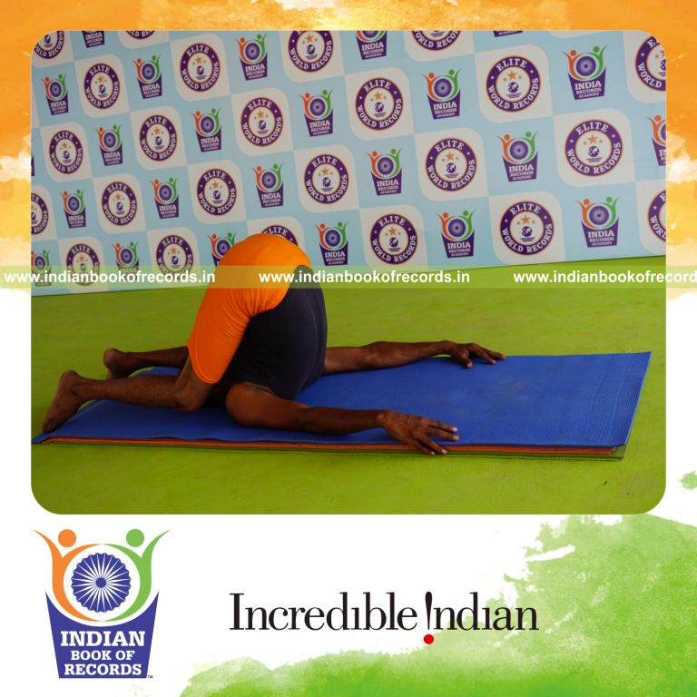 individual holding sivalingasana yoga pose blindfolded for record in Indian Book of Records