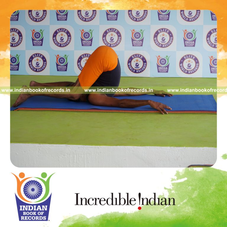 individual holding sivalingasana yoga pose for record in Indian Book of Records