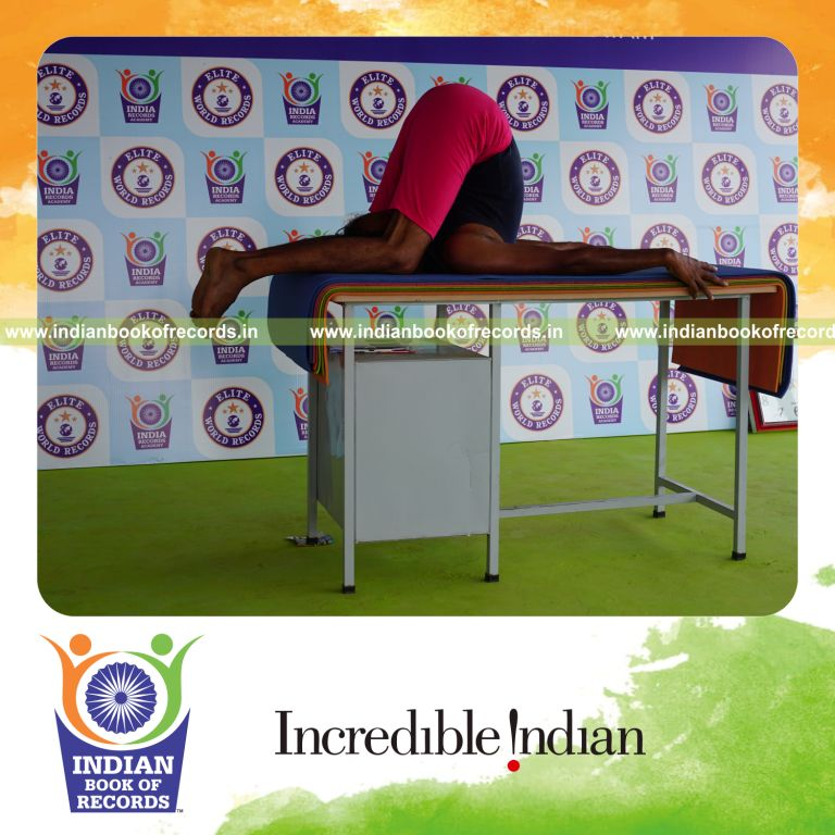 individual holding sivalingasana yoga pose on a table for record in Indian Book of Records