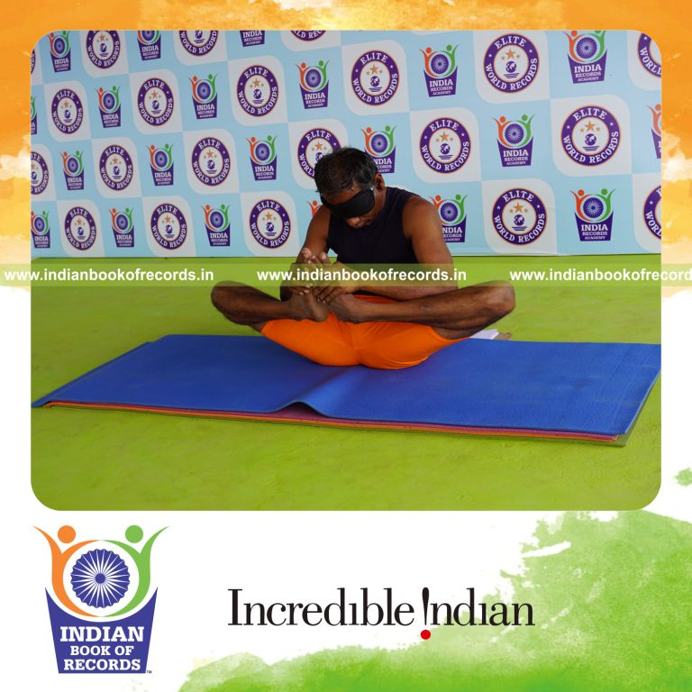 individual holding skandasana yoga pose blindfolded for record in Indian Book of Records