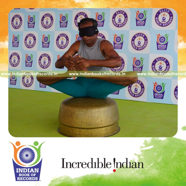 individual holding skandasana yoga pose blindfolded on a vessel for record in Indian Book of Records