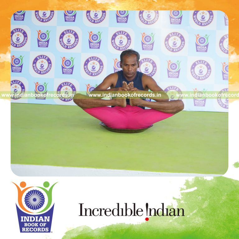 individual holding skandasana yoga pose on a brass plate for record in Indian Book of Records