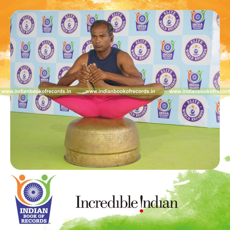 individual holding skandasana yoga pose on a vessel for record in Indian Book of Records