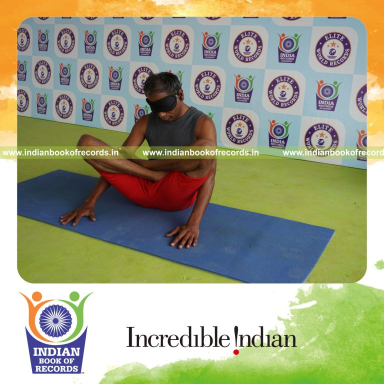individual holding thulangasana yoga pose blindfolded for record in Indian Book of Records