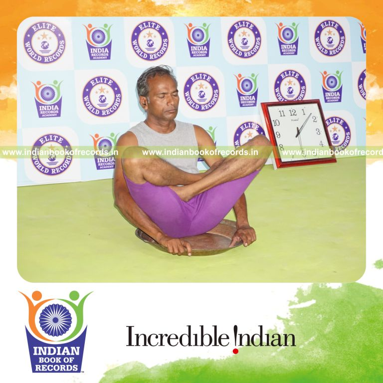 individual holding thulangasana yoga pose on a brass plate for record in Indian Book of Records