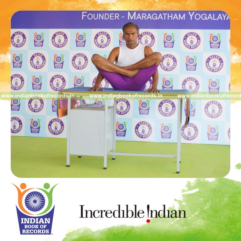 individual holding thulangasana yoga pose on a table for record in Indian Book of Records