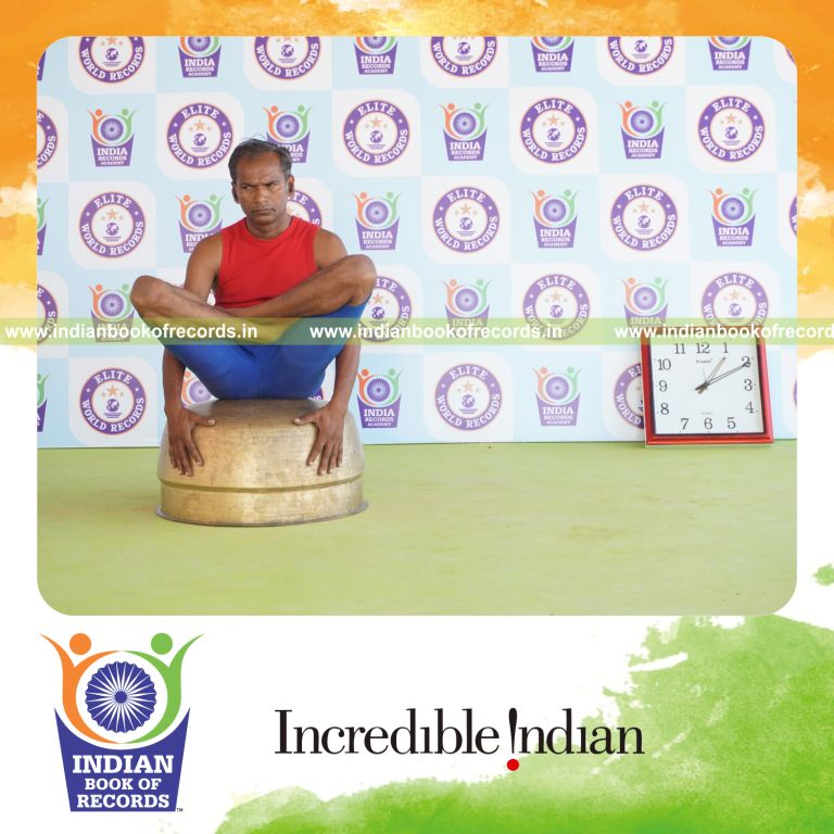 individual holding thulangasana yoga pose on a vessel for record in Indian Book of Records