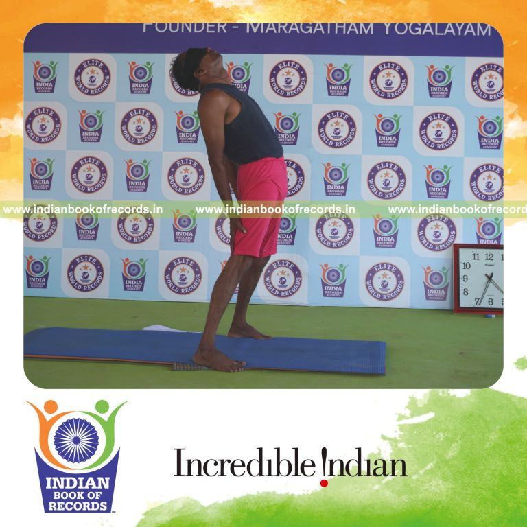 an individual holding trianga mukthasana yoga pose blindfolded for the longest duration with flexibility and control for a record in Indian Book of Records
