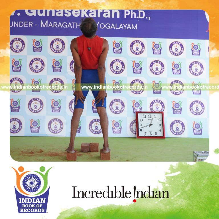 individual holding trianga mukthasana yoga pose on bricks for record in Indian Book of Records