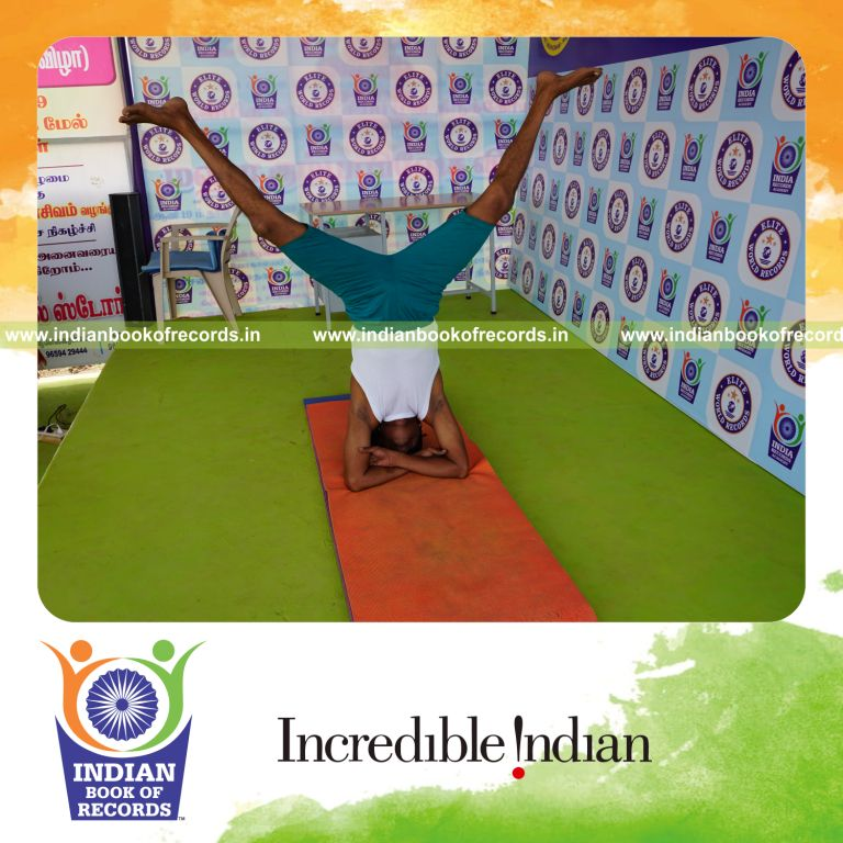 an individual holding upavistha baddha hastha sirsasana yoga pose blindfolded continuously for the longest duration with balance and control for a record in Indian Book of Records