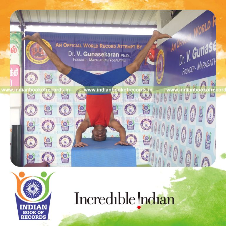 individual holding upavistha mukta sirsasana yoga pose on a table for record in Indian Book of Records