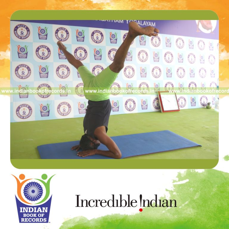 an individual holding upavistha salamba sirsasana yoga pose blindfolded for the longest duration with balance and strength for a record in Indian Book of Records
