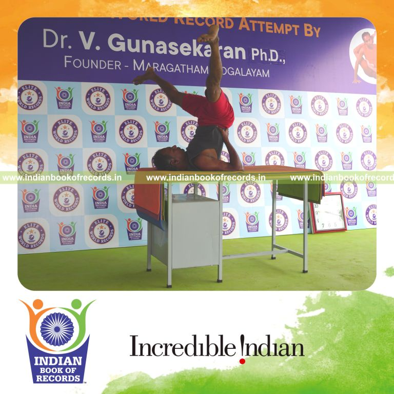 individual holding upavistha sarvangasana yoga pose on a table for record in Indian Book of Records