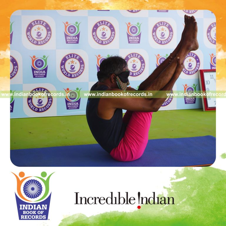an individual holding urdhva mukha paschimottanasana yoga pose blindfolded for the longest duration with flexibility and control for a record in Indian Book of Records
