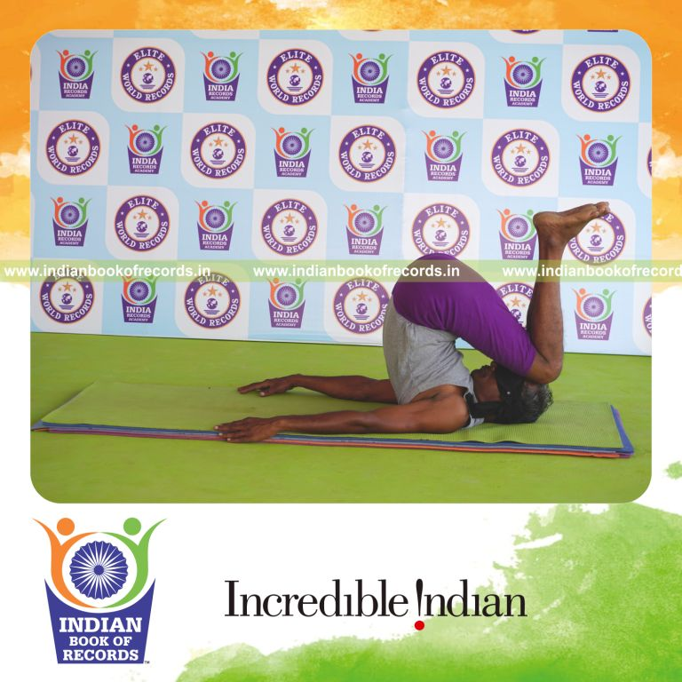 individual holding urdhva salamba sarvangasana yoga pose blindfolded for record in Indian Book of Records