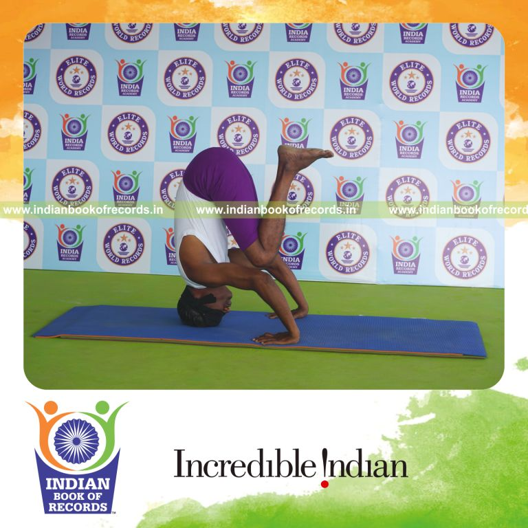 individual holding urdhva salamba sirsasana second type yoga pose blindfolded for record in Indian Book of Records