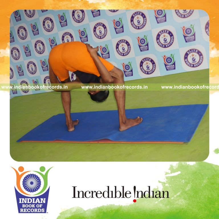 individual holding uthitha titibasana yoga pose blindfolded for record in Indian Book of Records